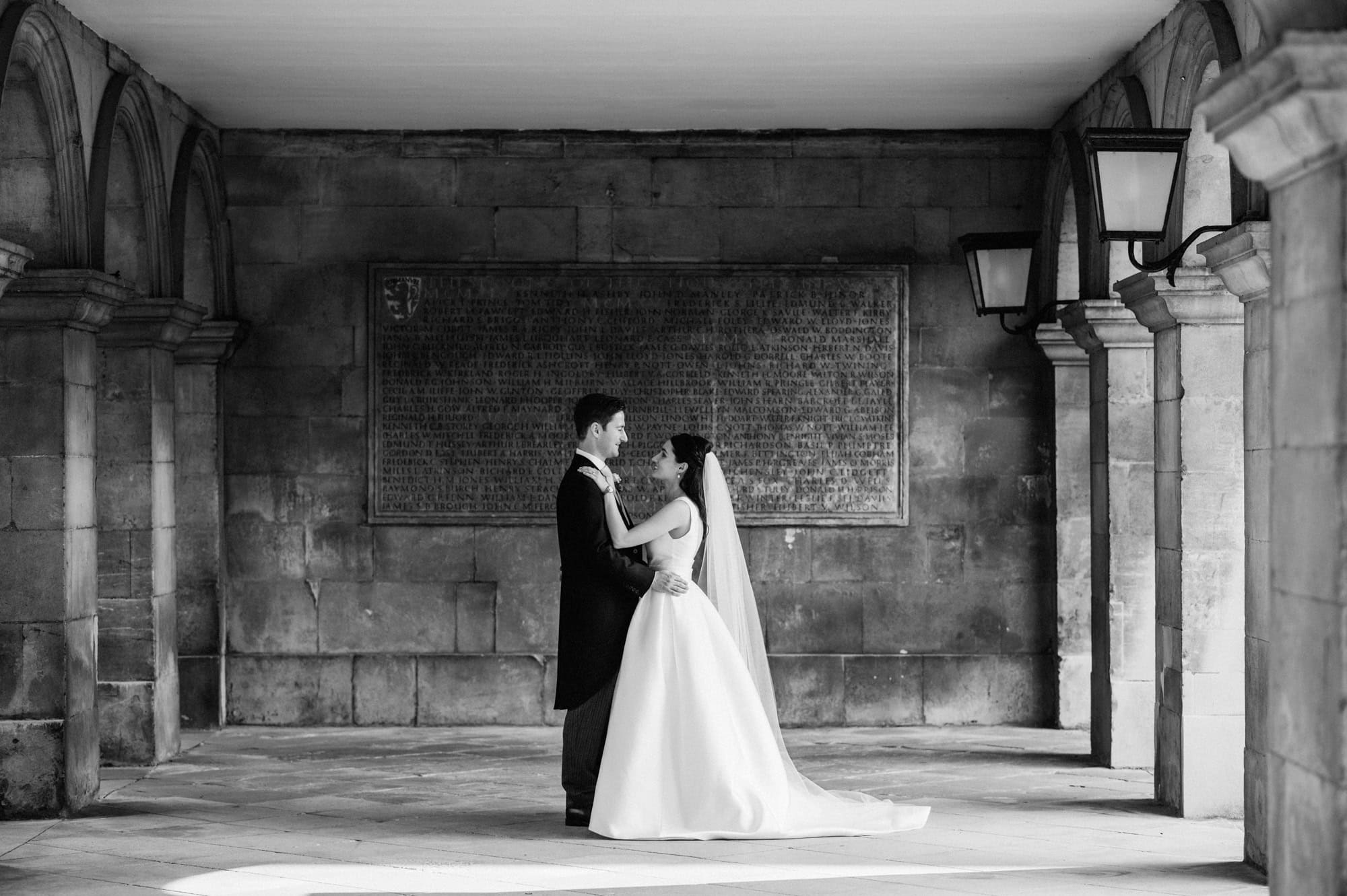 Newlywed portraits in the cloisters at Emmanuel College in Cambridge