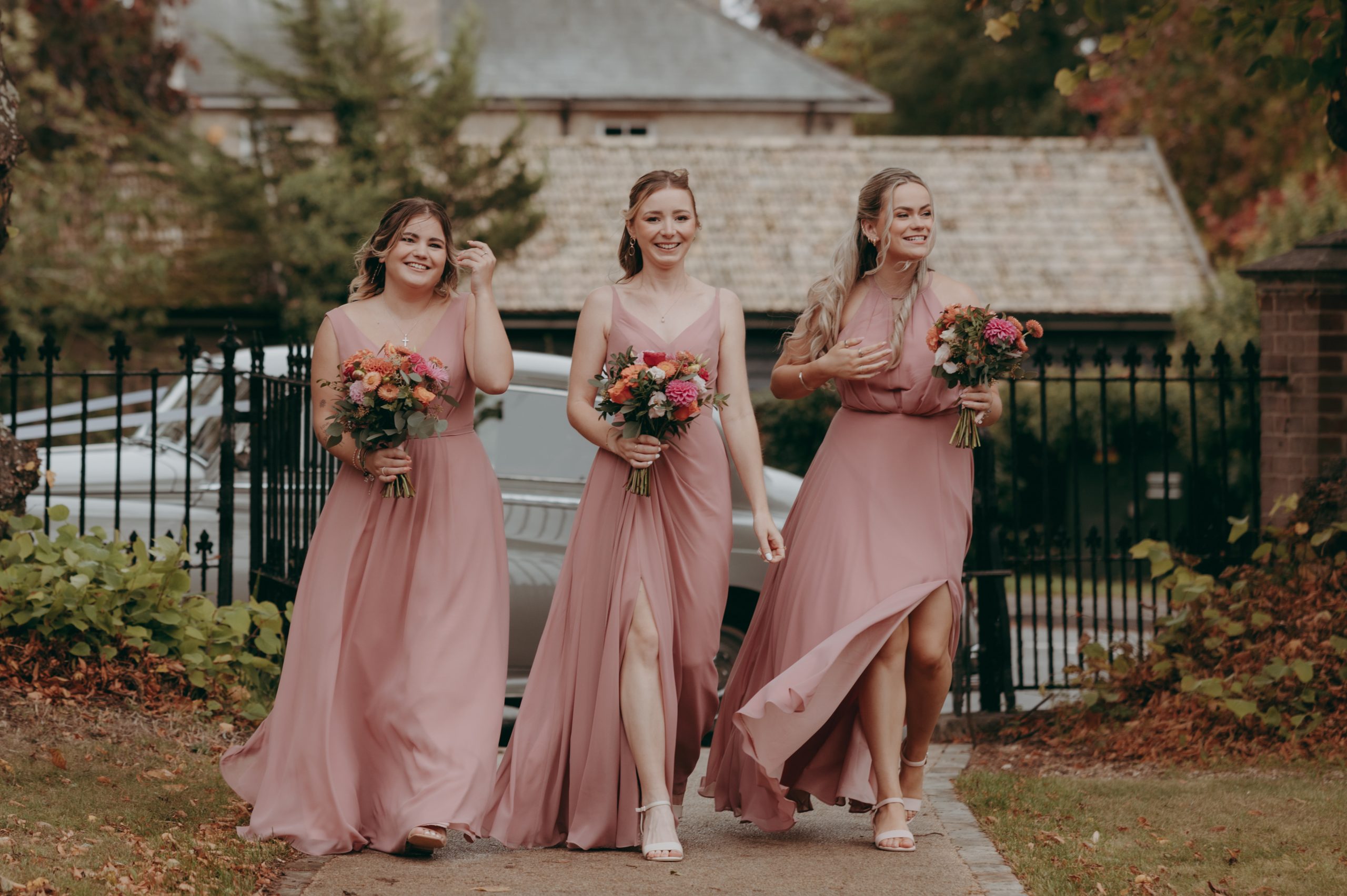 bridesmaids smailling and waling together to wedding ceremony in cambridge