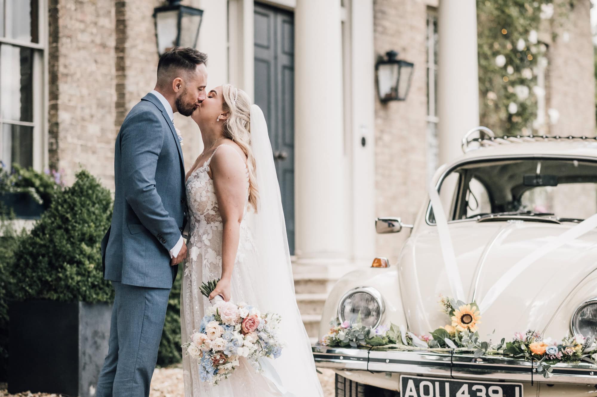 Bride and Groom Kiss at the front of Shortmead House