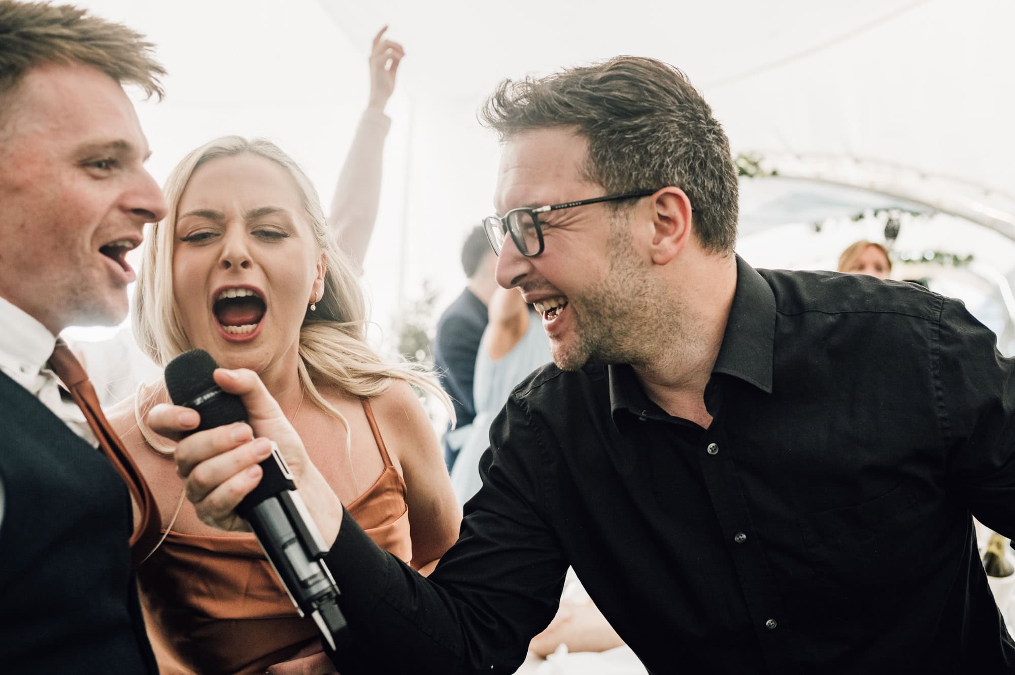 Wedding guests singing into mic at Bedfordshire Wedding Venue Shortmead House