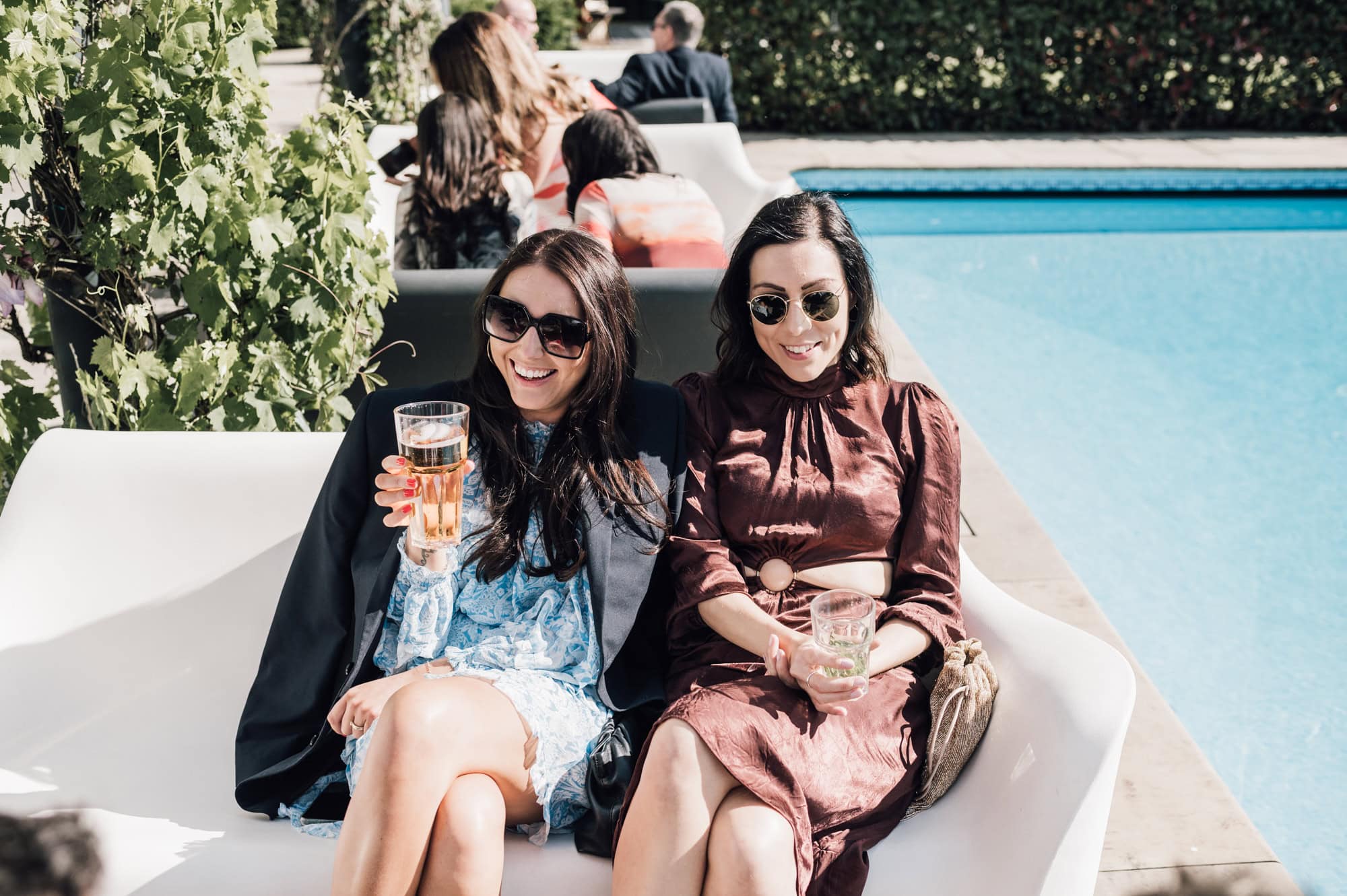 Wedding guests enjoying drinks by the pool at Shortmead House Wedding