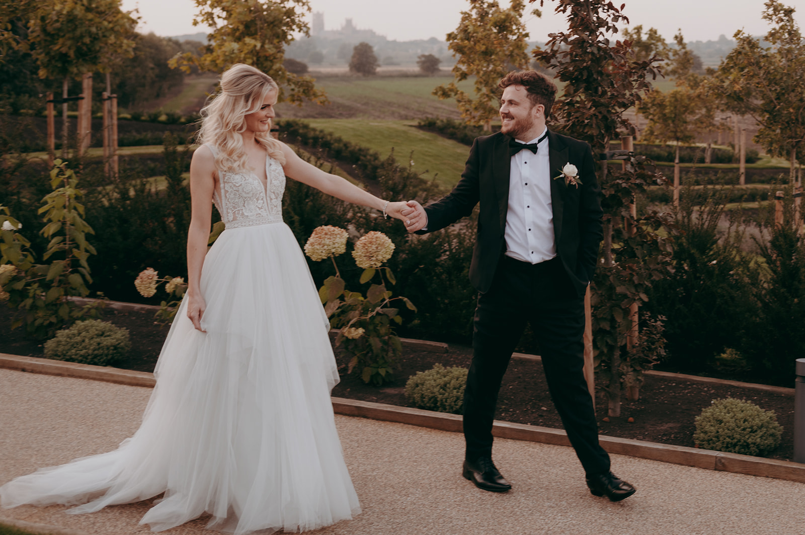 Bride and Groom walking the grounds at The Old Hall in Ely