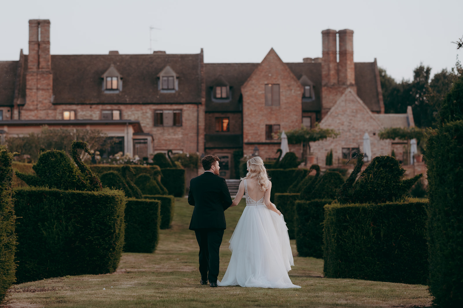 Couple walking away in portrati at The Old Hall Ely
