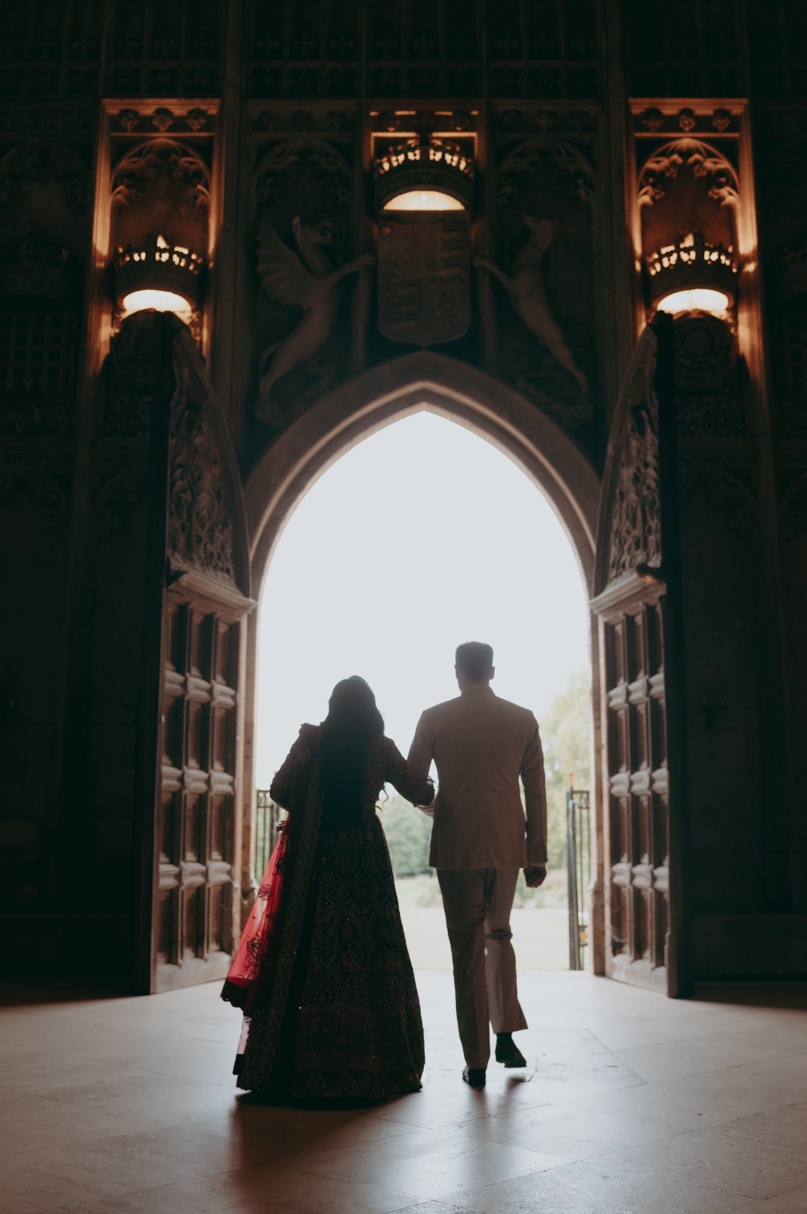 Couple exiting the grand Kings College Chapel at wedding in Cambridge