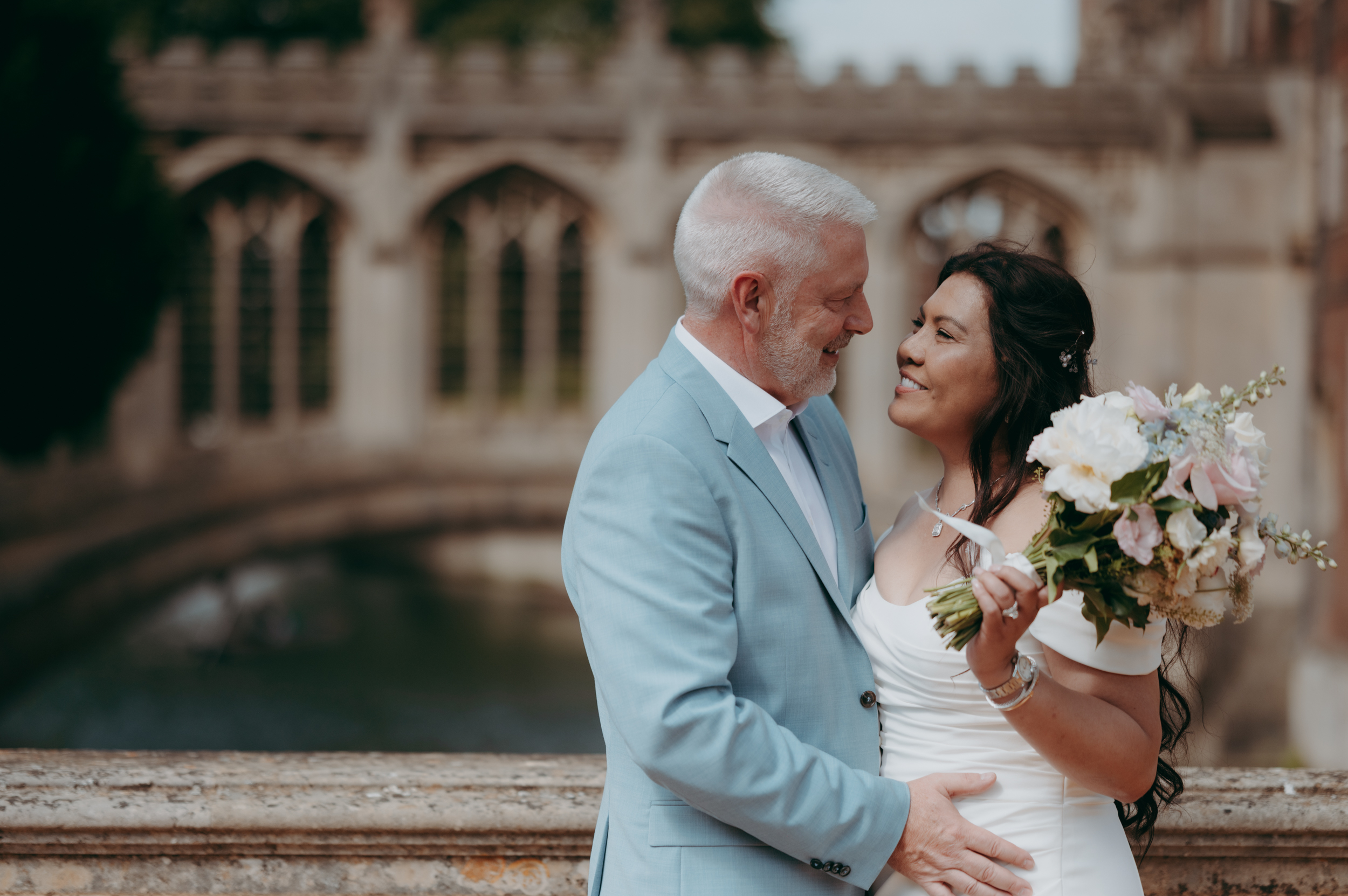 Bride and Groom in the grounds of St John's College with the Bridge of Sighs behind. 